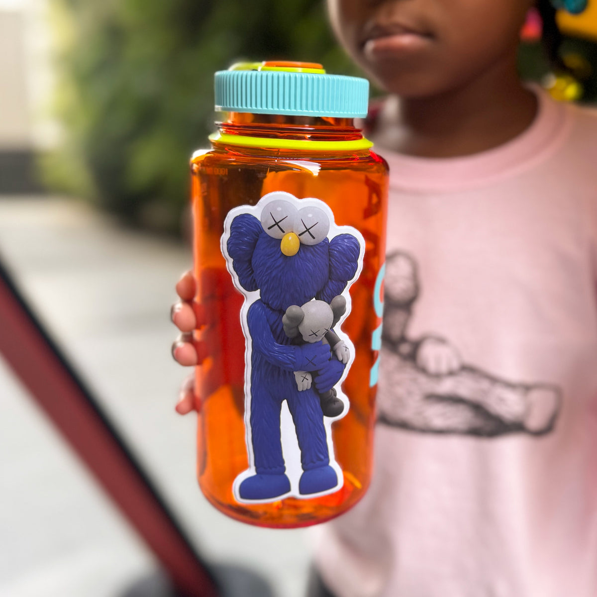 Puffy Sticker on clear orange water bottle.