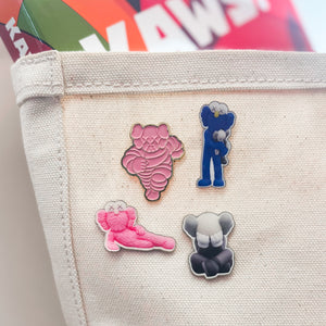 files/KAWS-pins-lifestyle_2048x_35ecae46-7449-4236-ae8f-53ff3855a42d.jpg