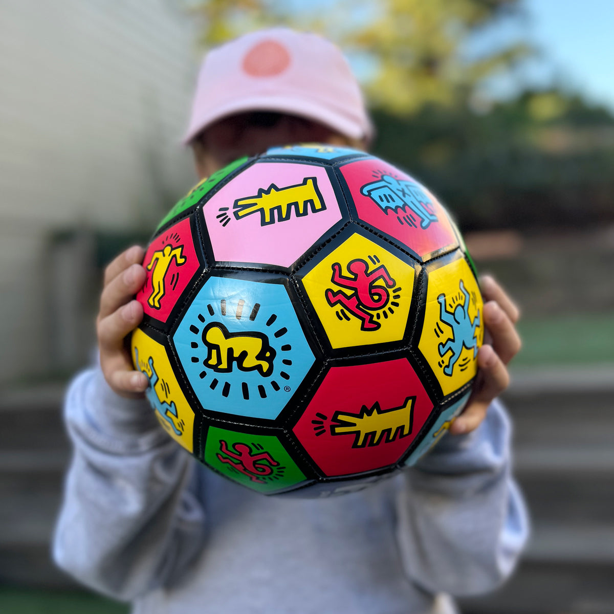 Child holding soccer ball.