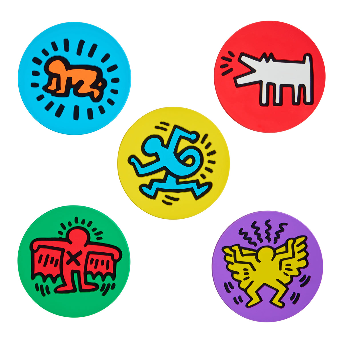 Five circular coasters featuring Keith Haring's signature pop-art style symbols in bright colors: orange on blue, white on red, blue on yellow, red on green, and yellow on purple, arranged on a white background.