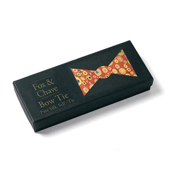 Black box with a colorful bow tie design and 'Fox & Chave' branding on a white background