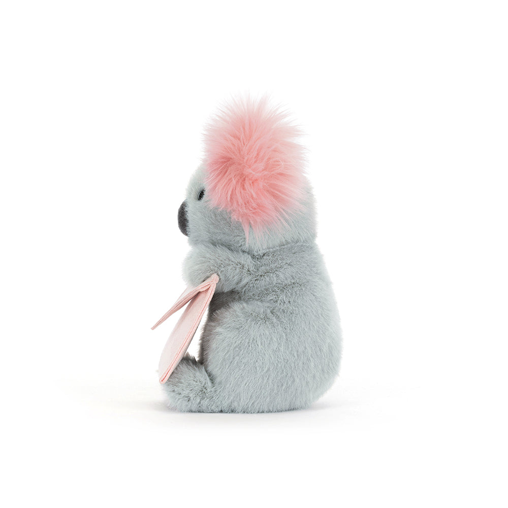 Plush koala toy holding a pink card on a white background