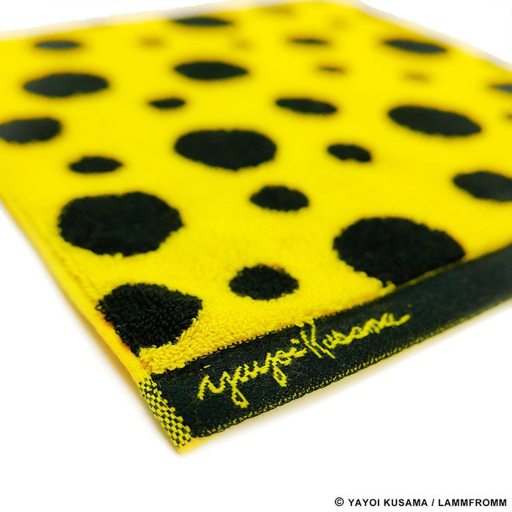 Close up view of artist signature on Yayoi Kusama Polka Dots Towel: Yellow and Black