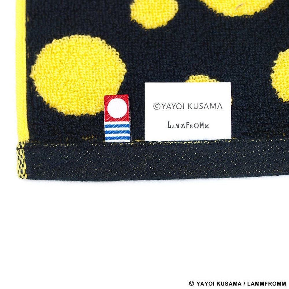 Close up view of the tag on Yayoi Kusama Polka Dots Towel: Yellow and Black
