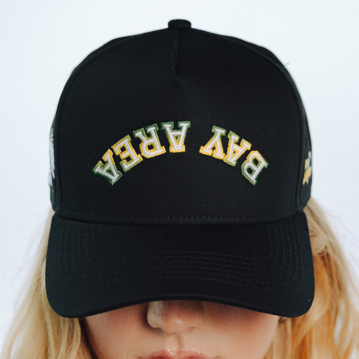 Black cap with 'BAY AREA' text on a white background