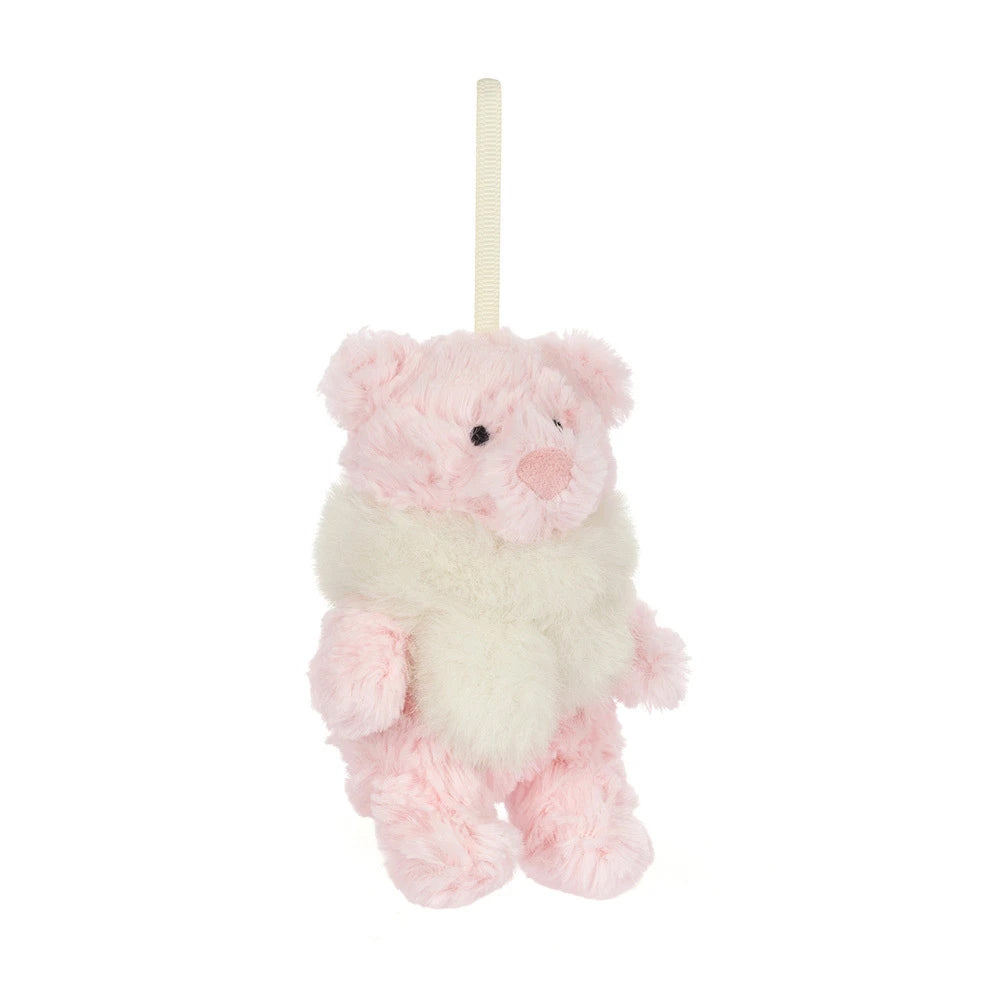 A small plush hanging bear ornament in soft pink and cream white faux fur, suspended by a cream ribbon on a plain white background.