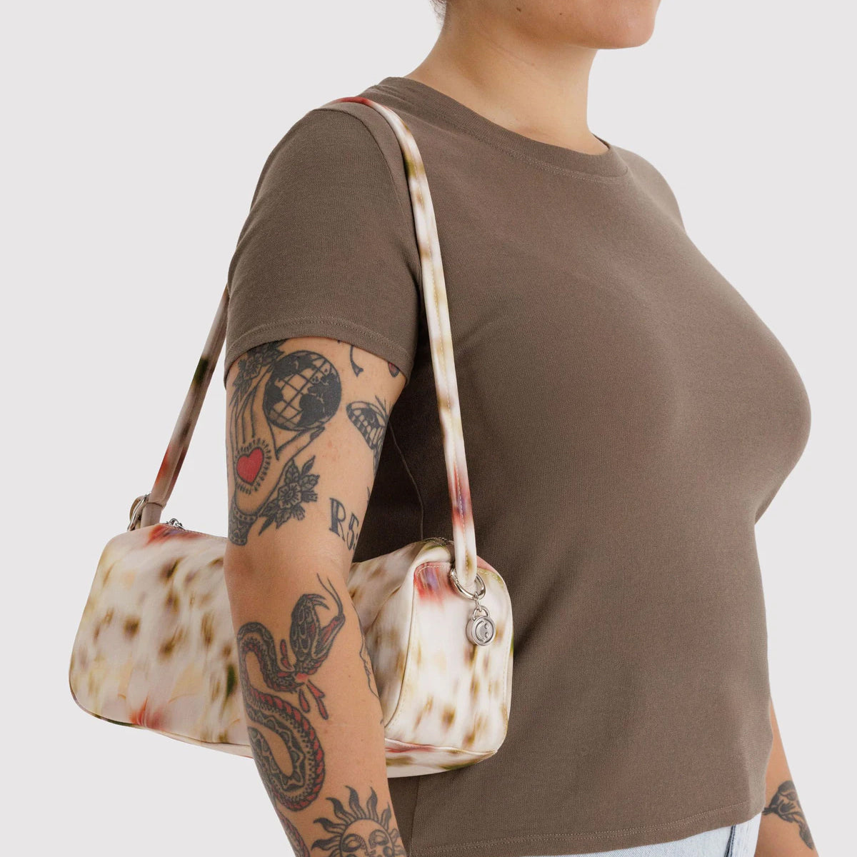 Abstract floral patterned handbag on a white background