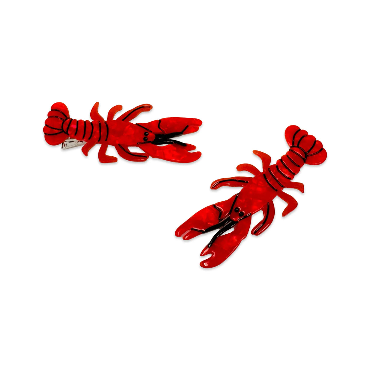 Two red lobster-shaped hair clips on a white background