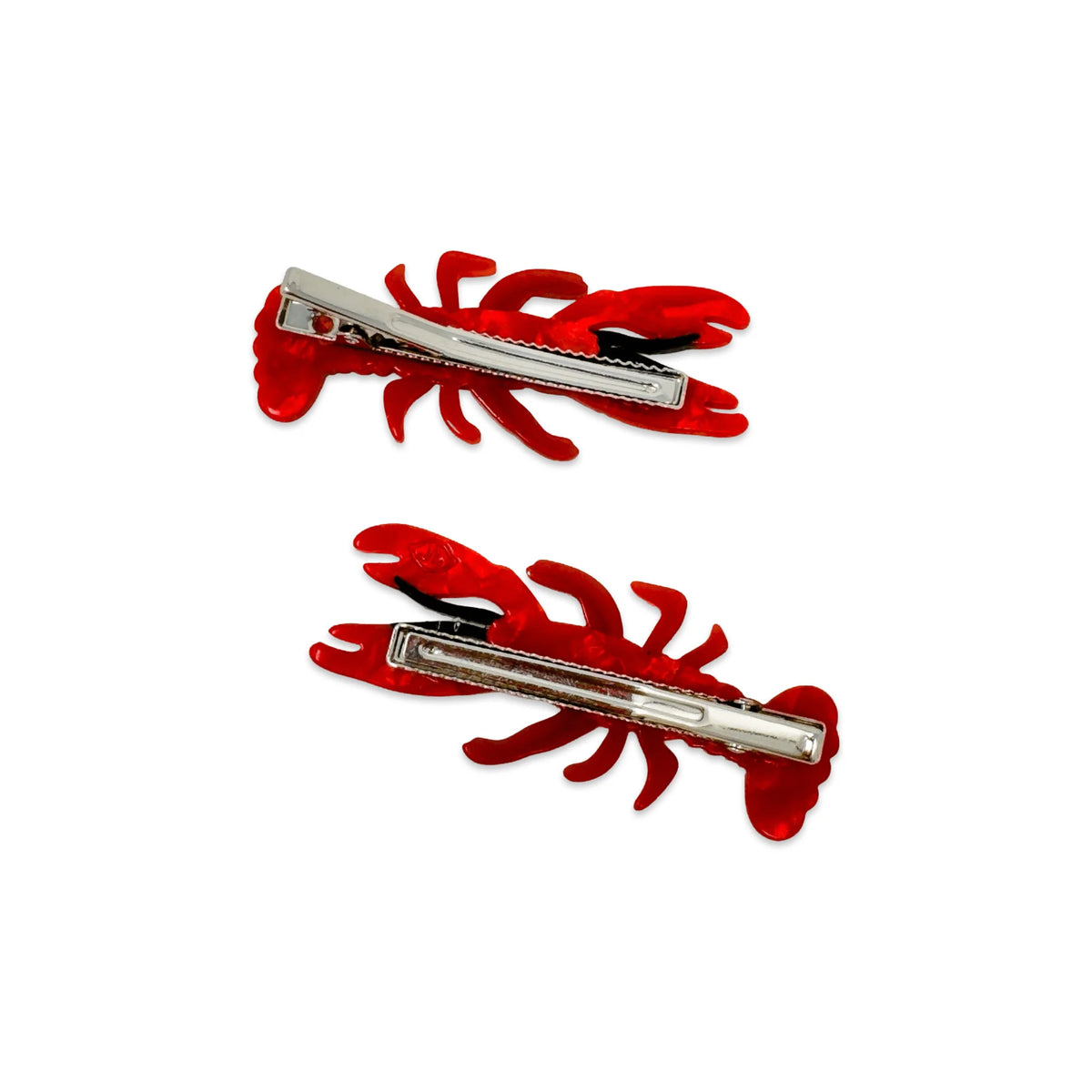 Two red lobster-shaped hair clips on a white background