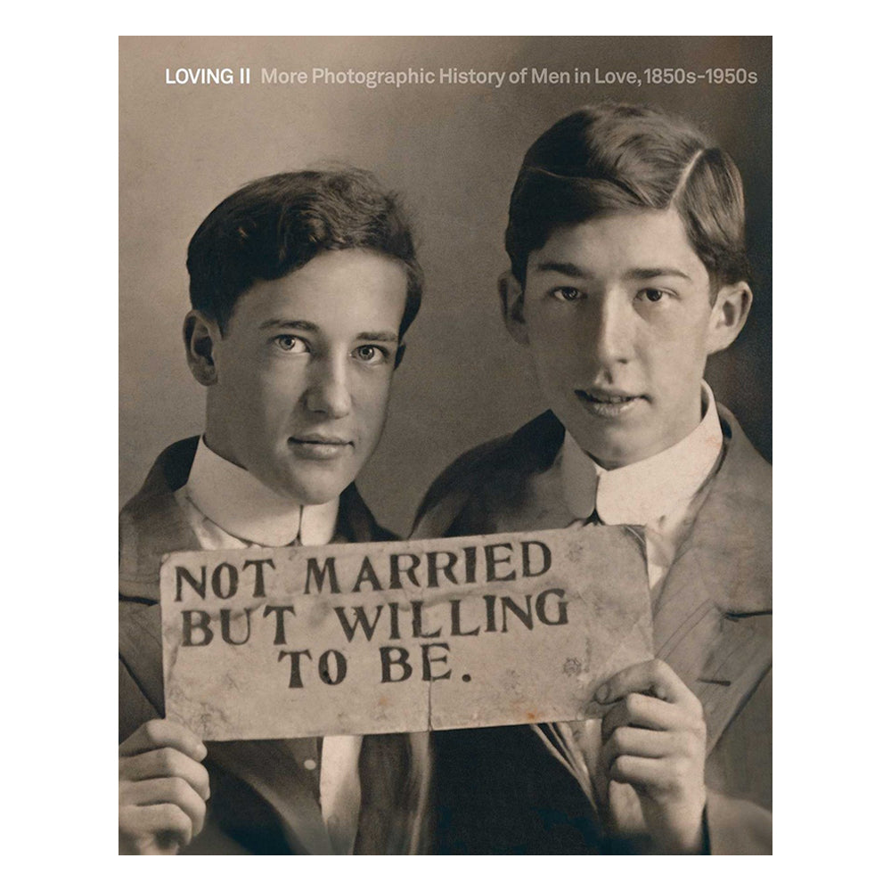 Two men holding a sign that reads 'Not Married But Willing To Be' in a vintage style.