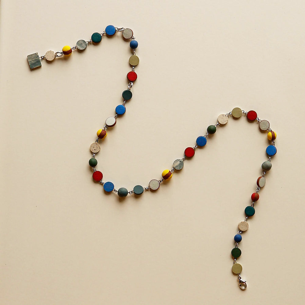 Necklace with multicolored beads on a beige background