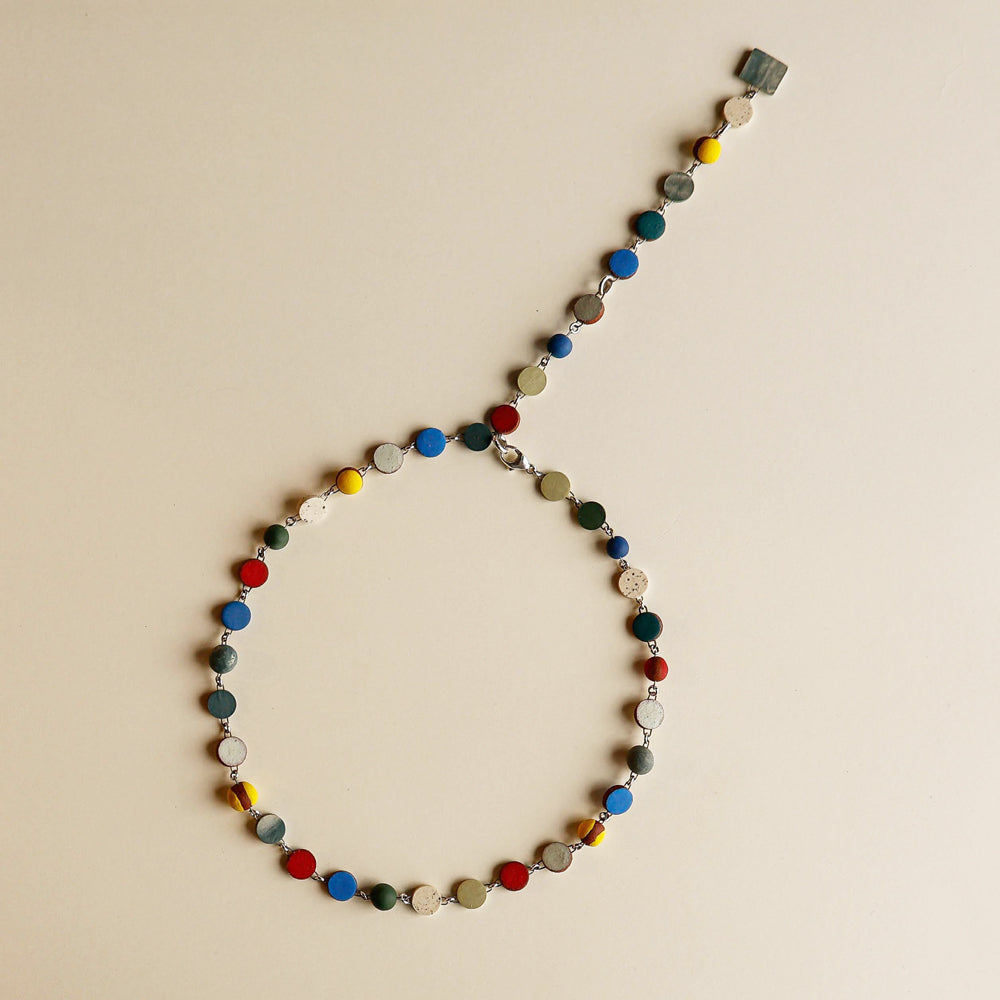 Necklace with multicolored beads on a beige background