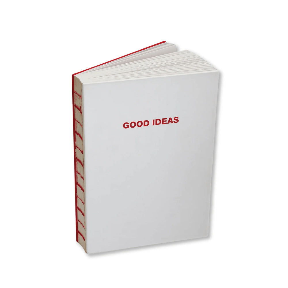 A hardcover notebook with a white cover and red spine, featuring the words 'GOOD IDEAS' printed in red on the front cover, set against a plain white background.