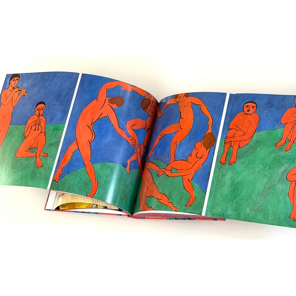 Open book with colorful illustrations of nude figures on a white background