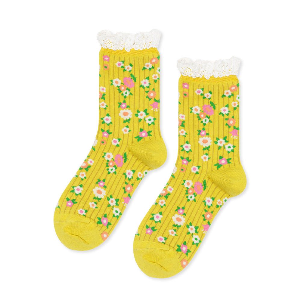 Yellow socks with floral pattern and white lace trim on a white background