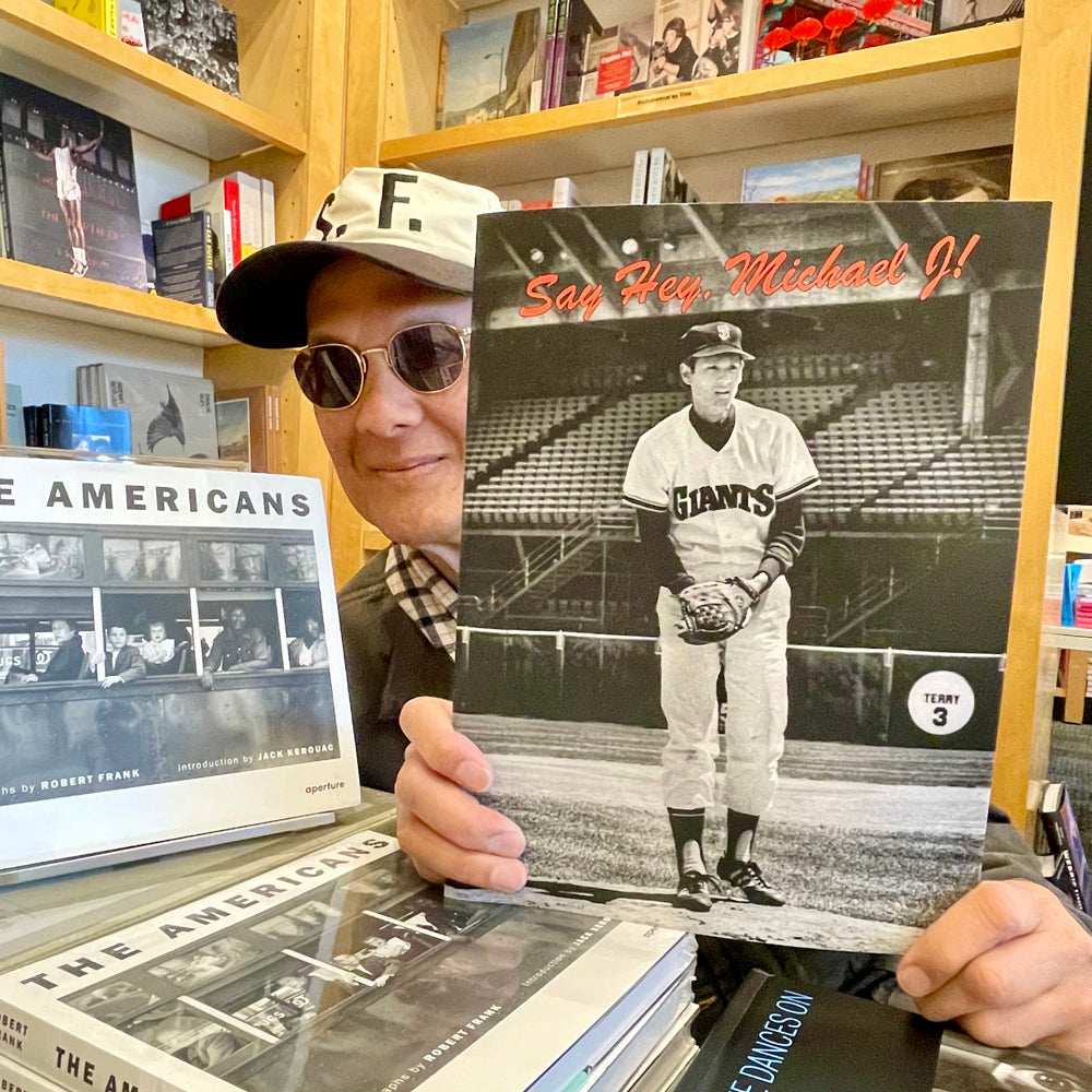 Michael Jang holding up zine.