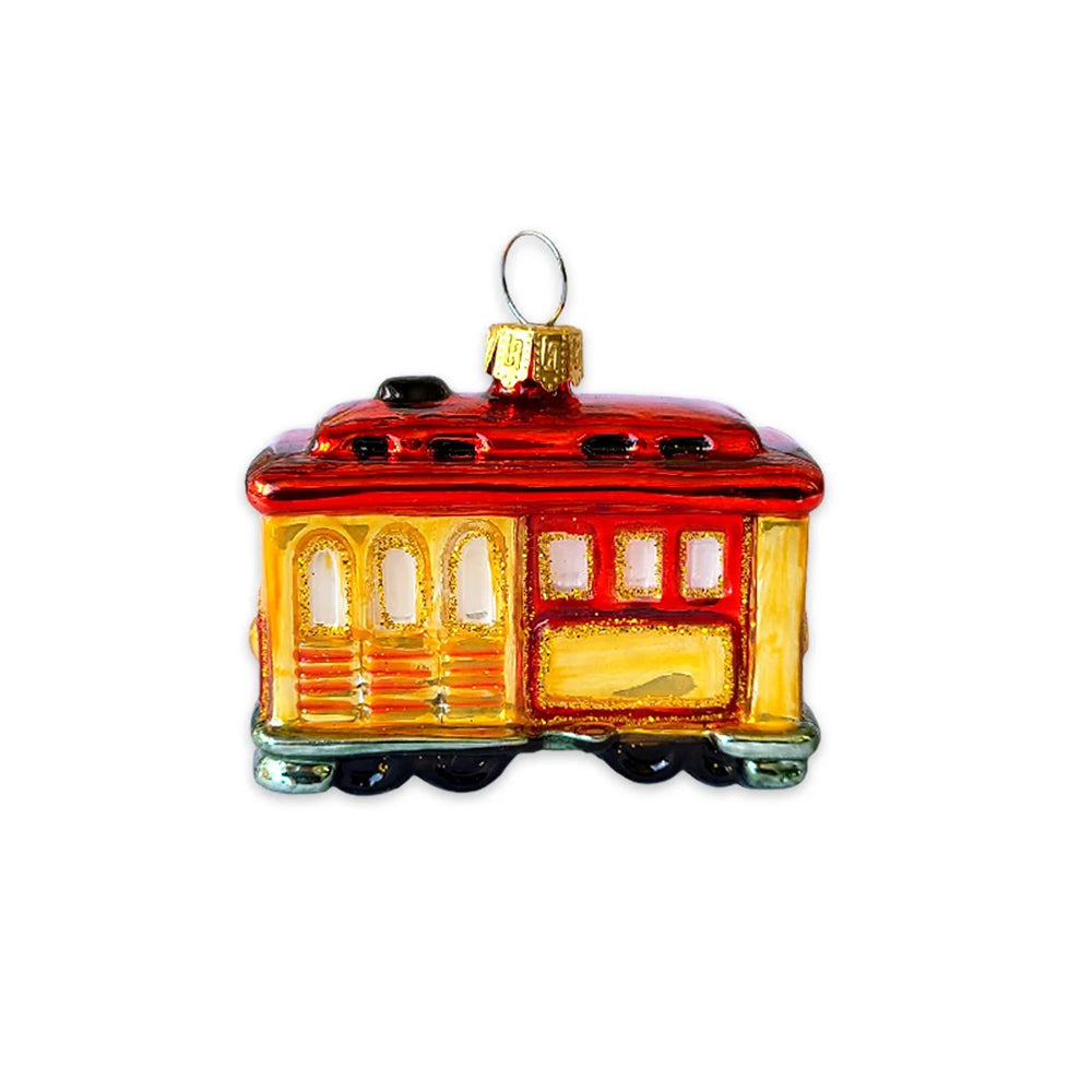 A vintage-style glass trolleybus ornament with a glossy red roof, yellow body, and gold hanging loop, shown on a plain white background.