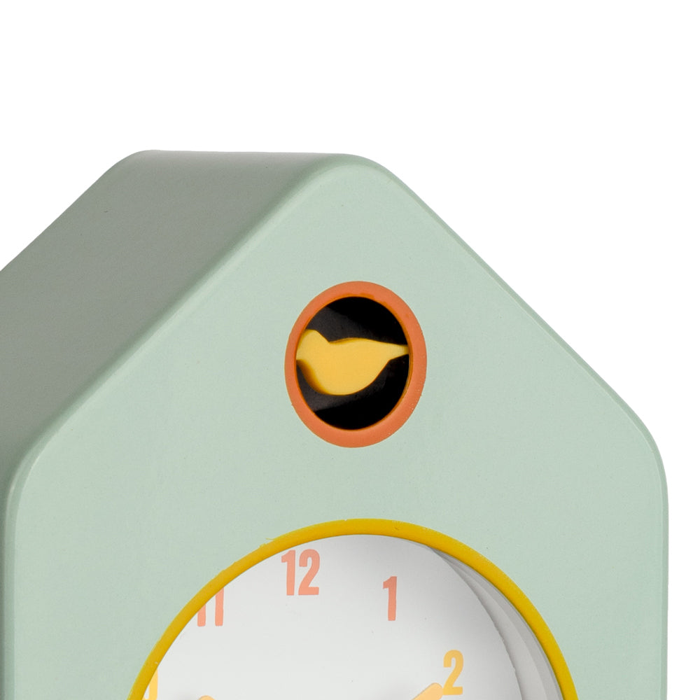 Cuckoo clock with a green body and yellow bird on a white background