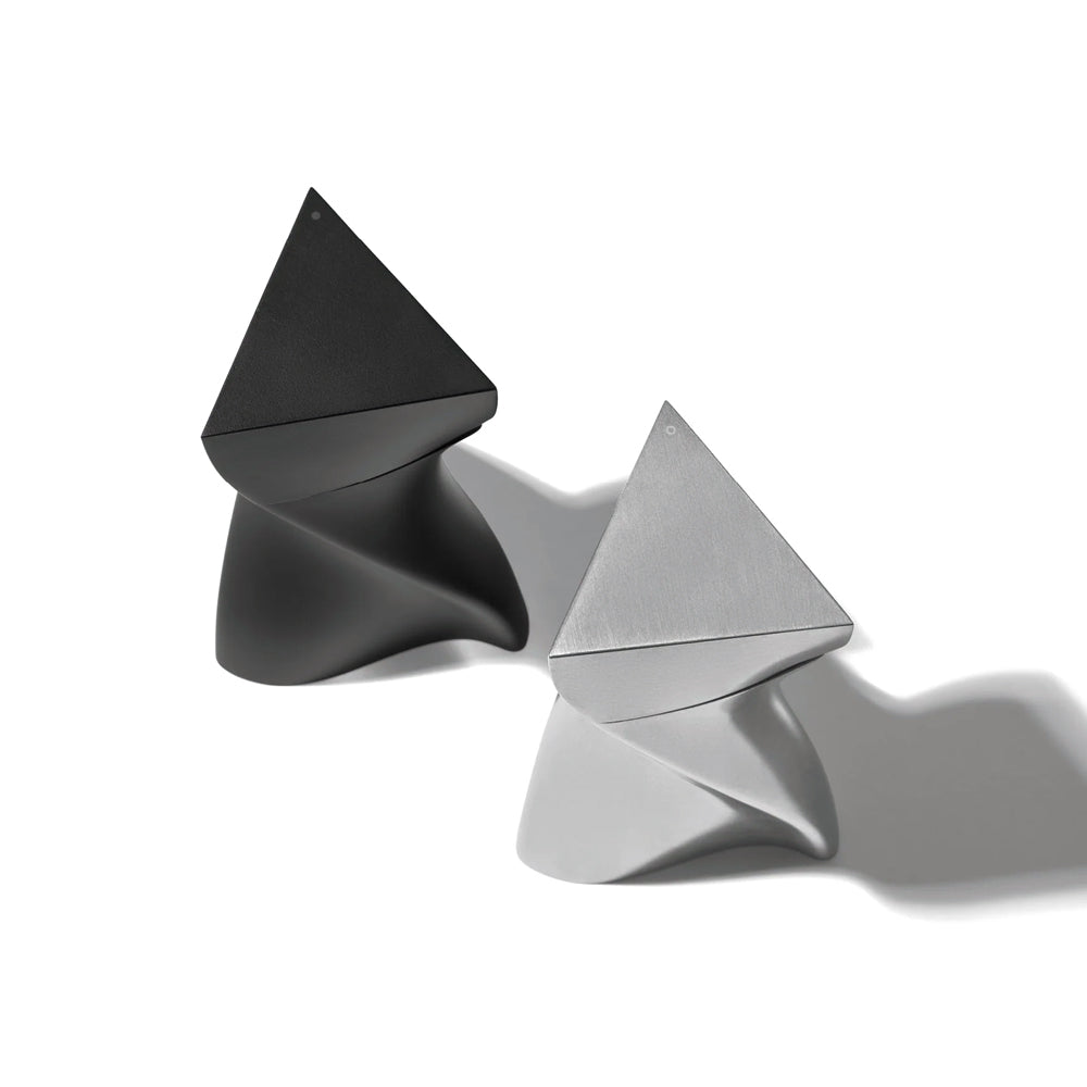 Two geometrically shaped objects, one black and one silver, on a white background.
