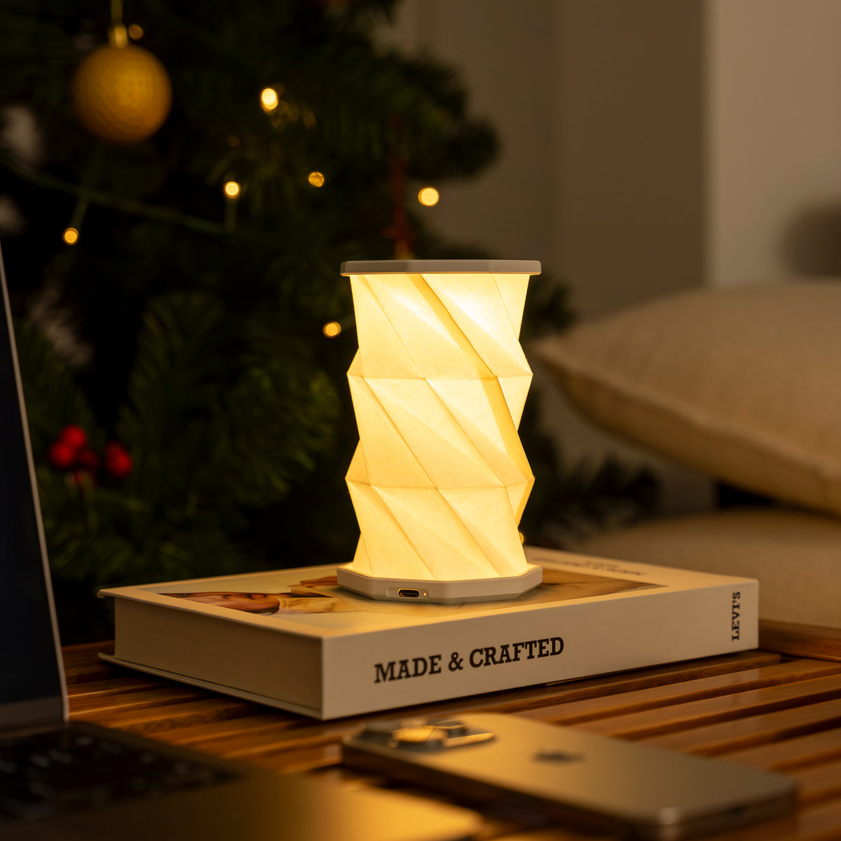 Hex light on a book with a blurred Christmas tree in the background