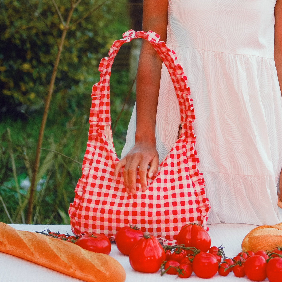 Momo bag with tomatoes and bread on a table outdoors