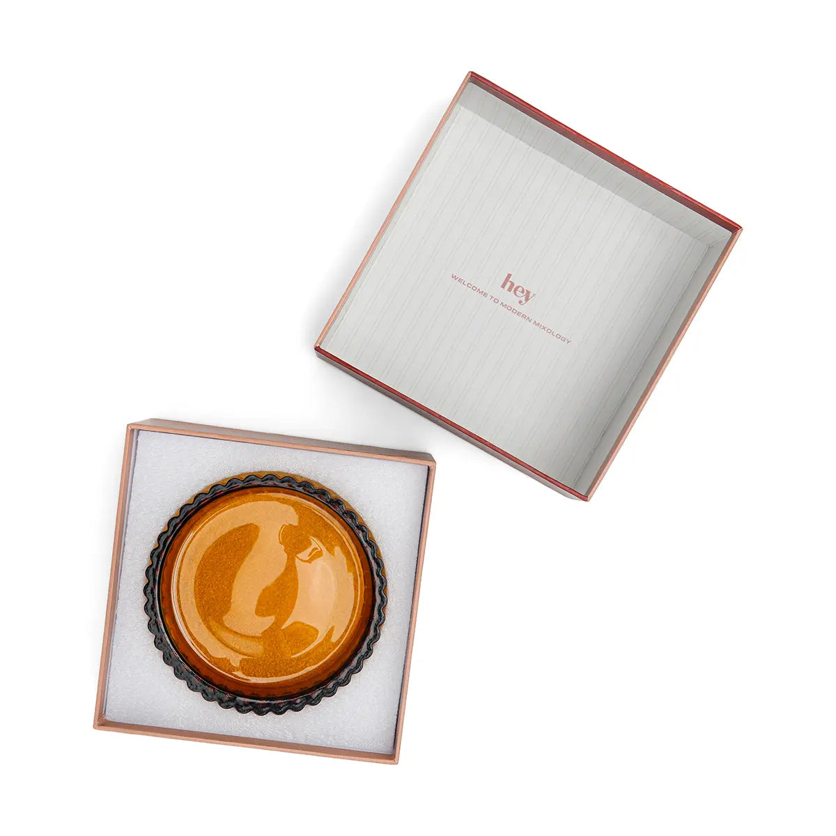 Decorative plate inside an open box on a white background