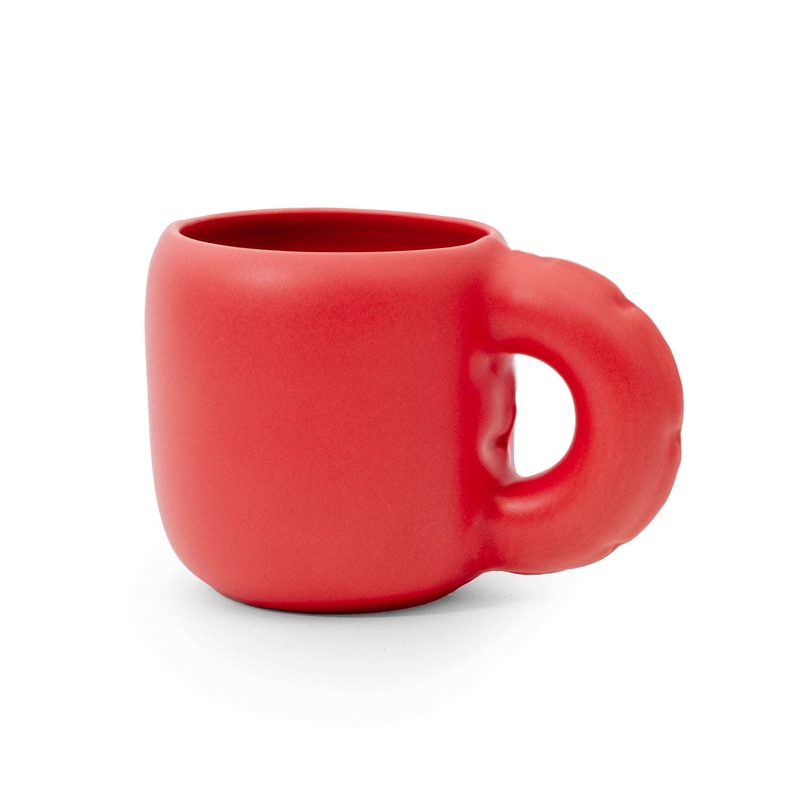 A bright red ceramic mug with a unique, rounded handle, shown on a clean white background.