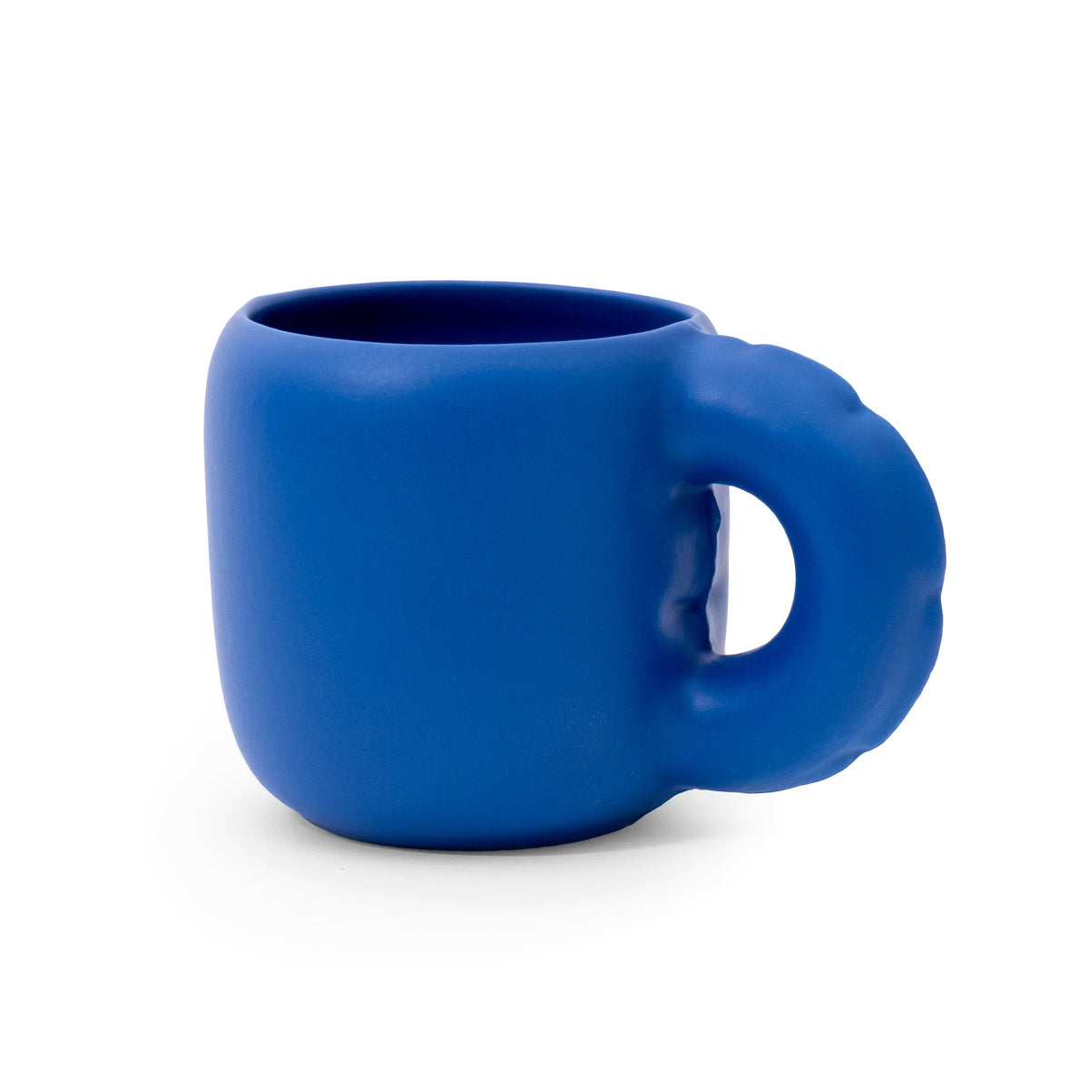 A bright blue ceramic mug with a unique, sculptural handle, shown on a clean white background.