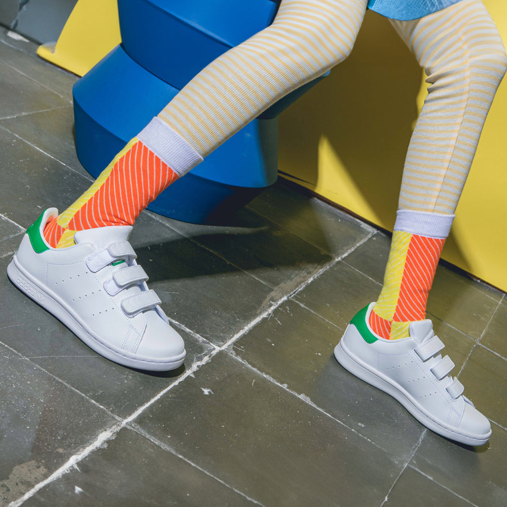 Kid model wearing socks with shoes.