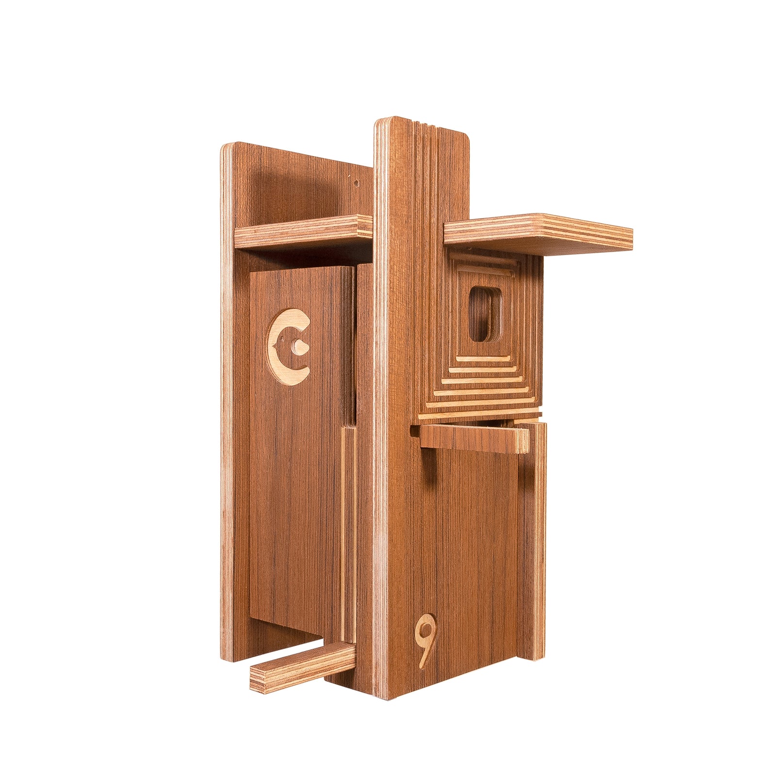 A wooden birdhouse-style decorative object with layered shelves, a recessed window, and engraved numbers and symbols, shown on a plain white background.