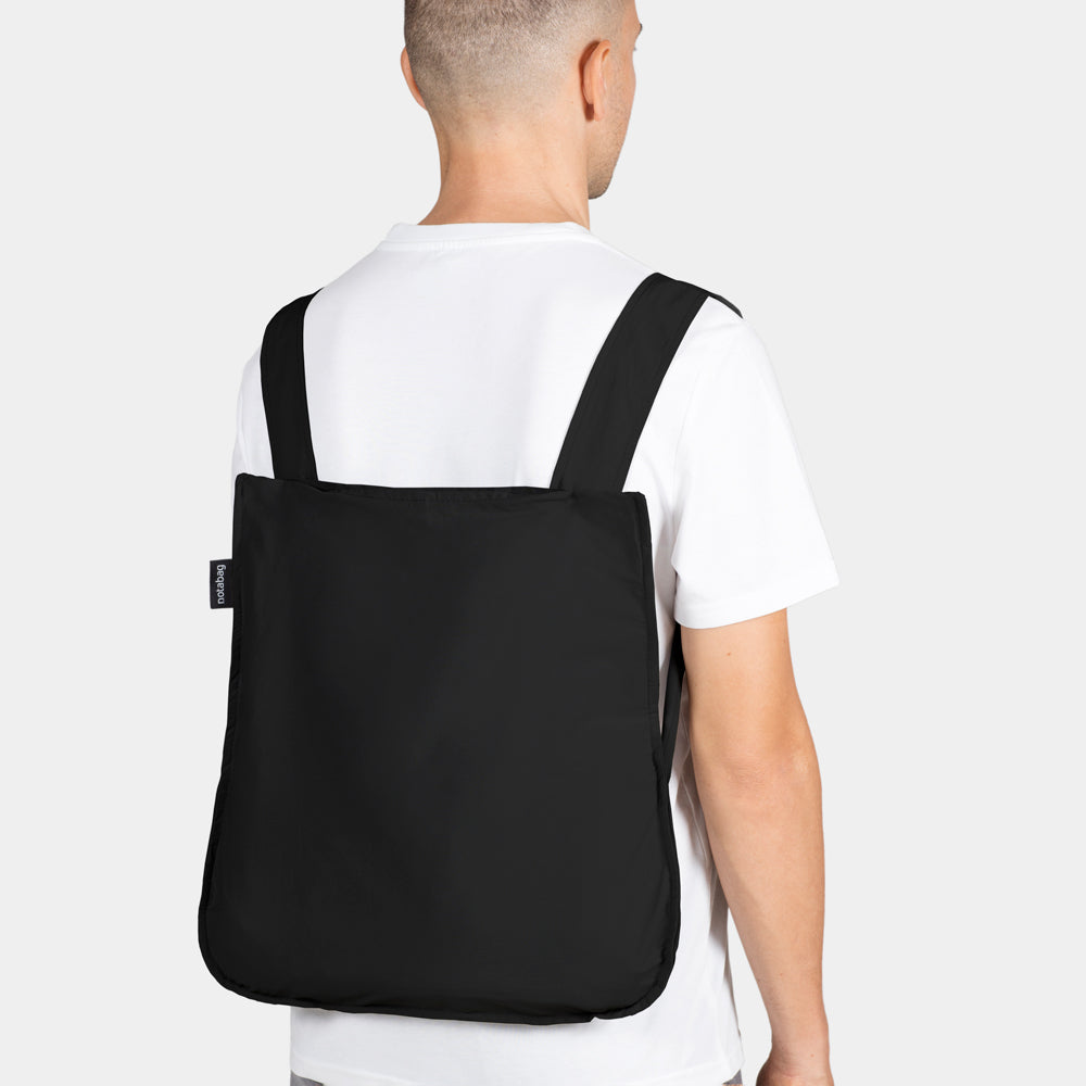 Model wearing bag as backpack.