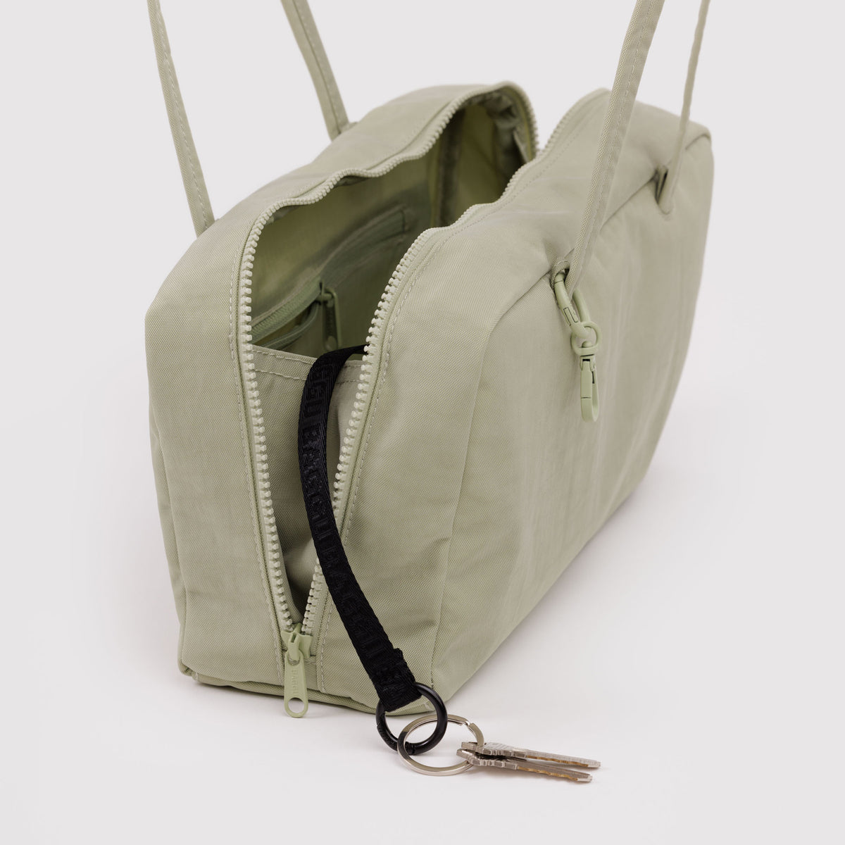 Pale green bag with a zipper on a white background