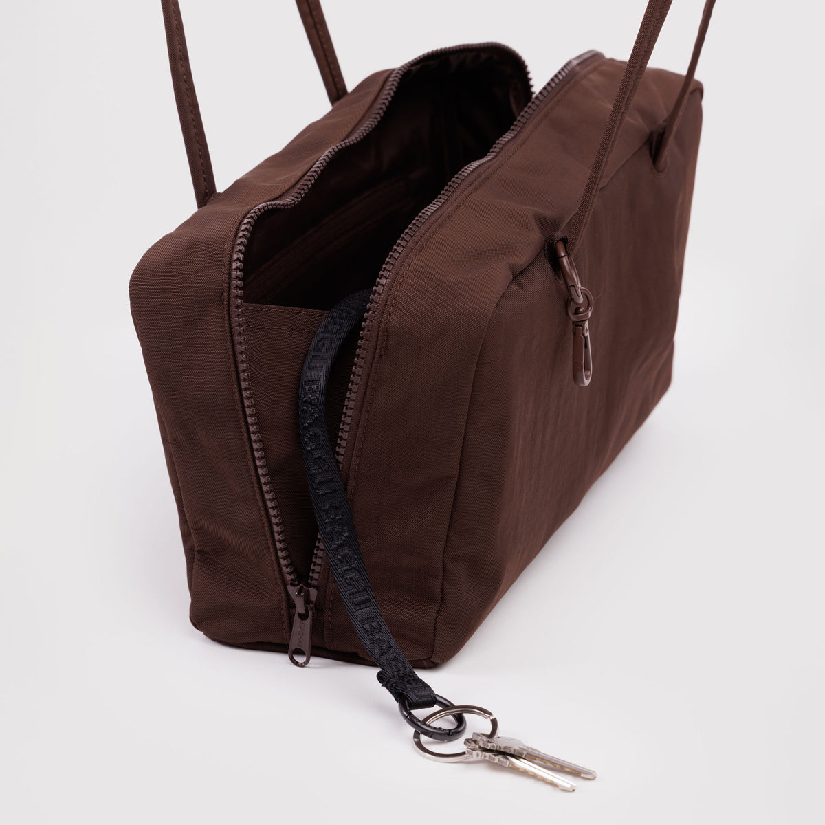 Brown bag with a key attached on a white background