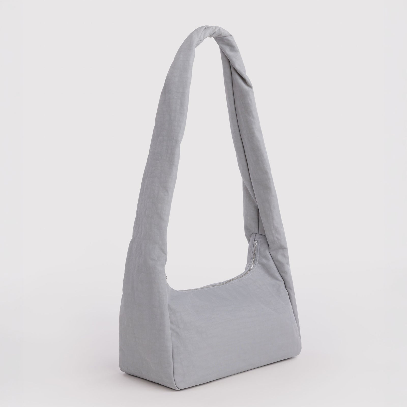A light gray fabric shoulder bag with a single long strap, shown against a plain white background.