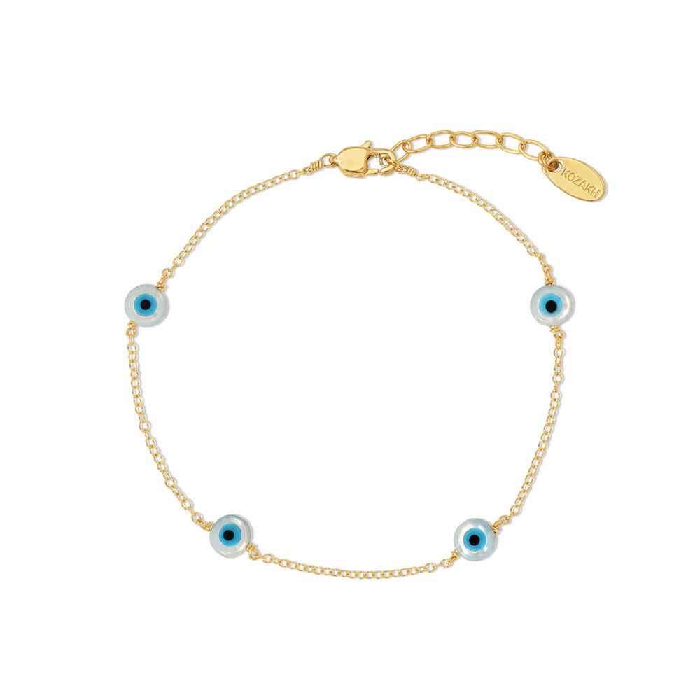 A delicate gold chain bracelet with four evil eye charms, featuring light blue and white beads with dark blue centers, displayed on a clean white background.