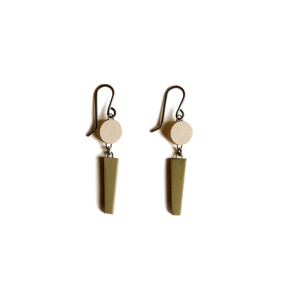 Pair of earrings with circular top and triangular bottom on a white background