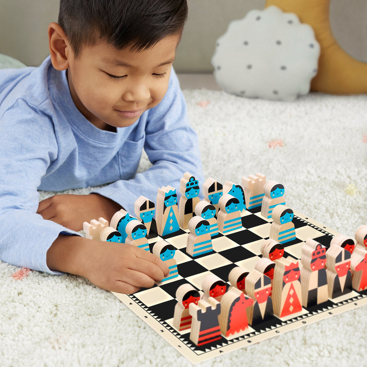 Child playing with a colorful wooden chess set on a checkered board.