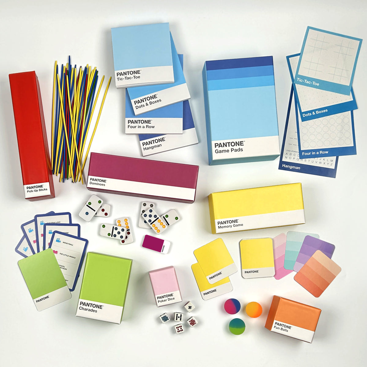 PANTONE Color Game Set with various colorful boxes, cards, dice, and sticks arranged on a clean white background.