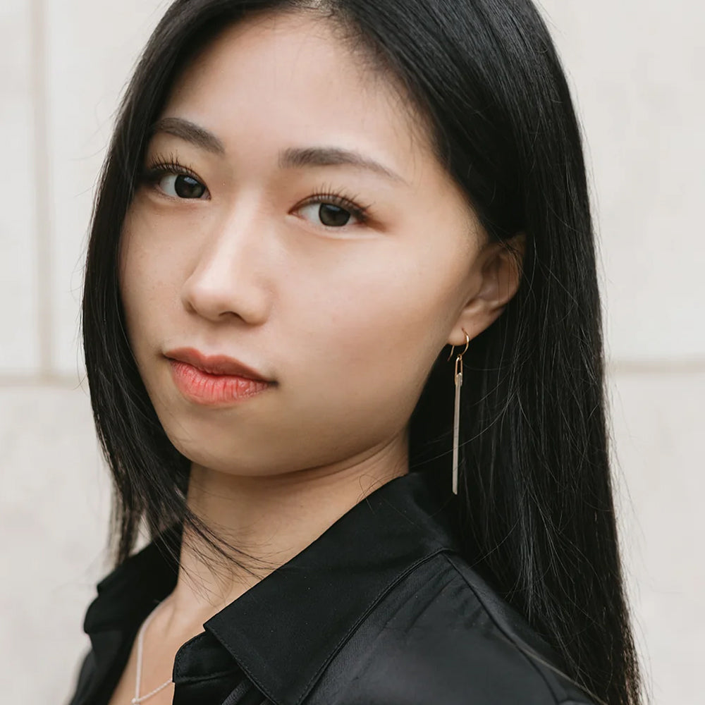 Woman wearing a black shirt with a neutral background