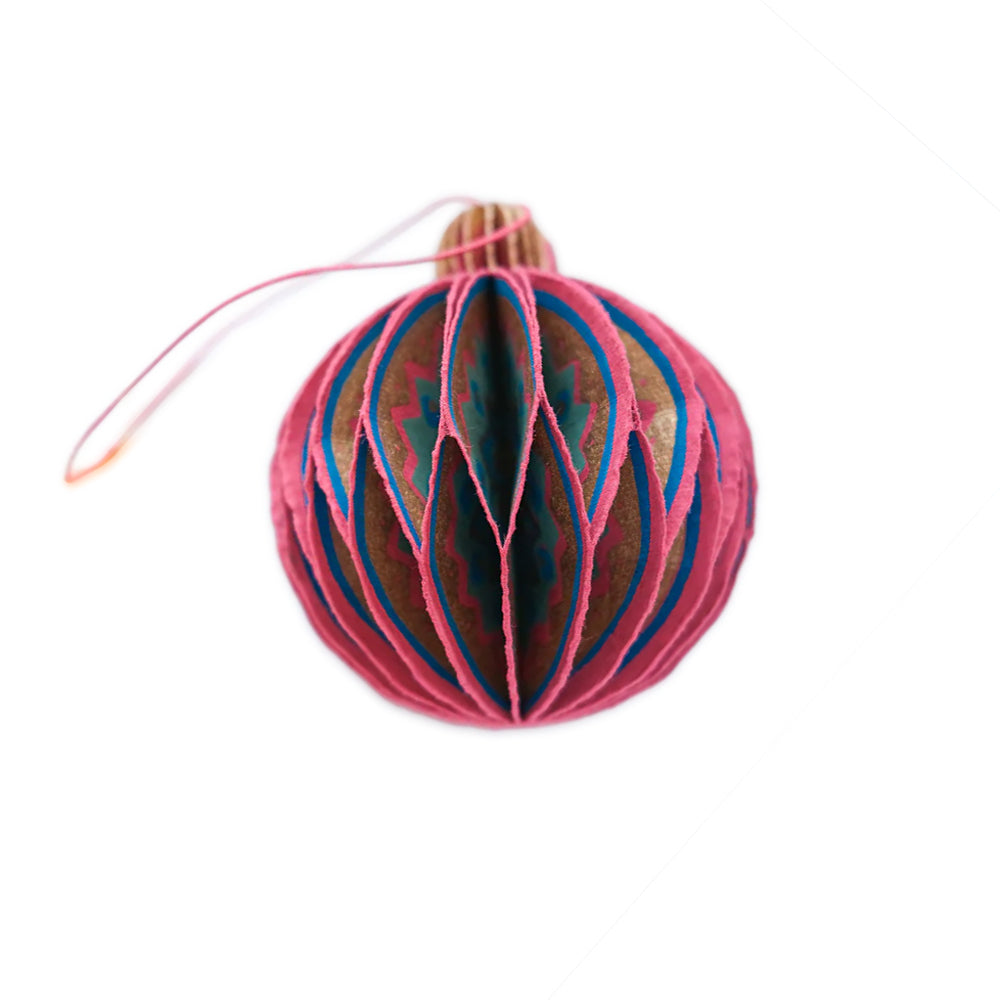 Decorative pink and blue paper ornament on a white background