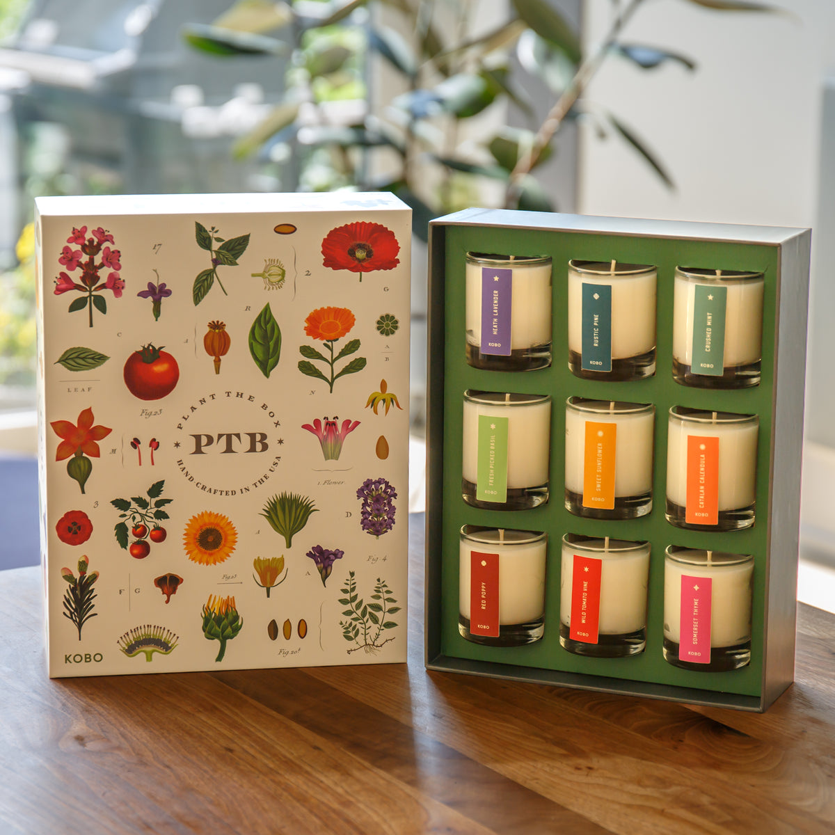 Set of candles in a decorative box with floral design on the packaging