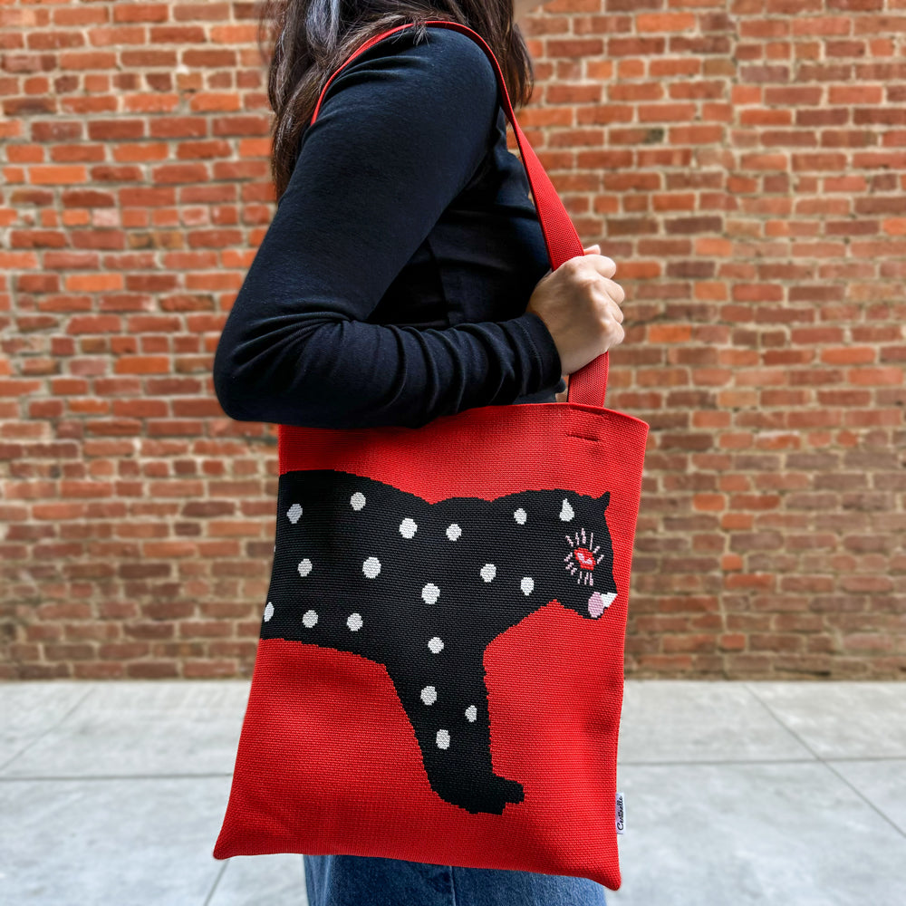 Model wearing tote over shoulder.