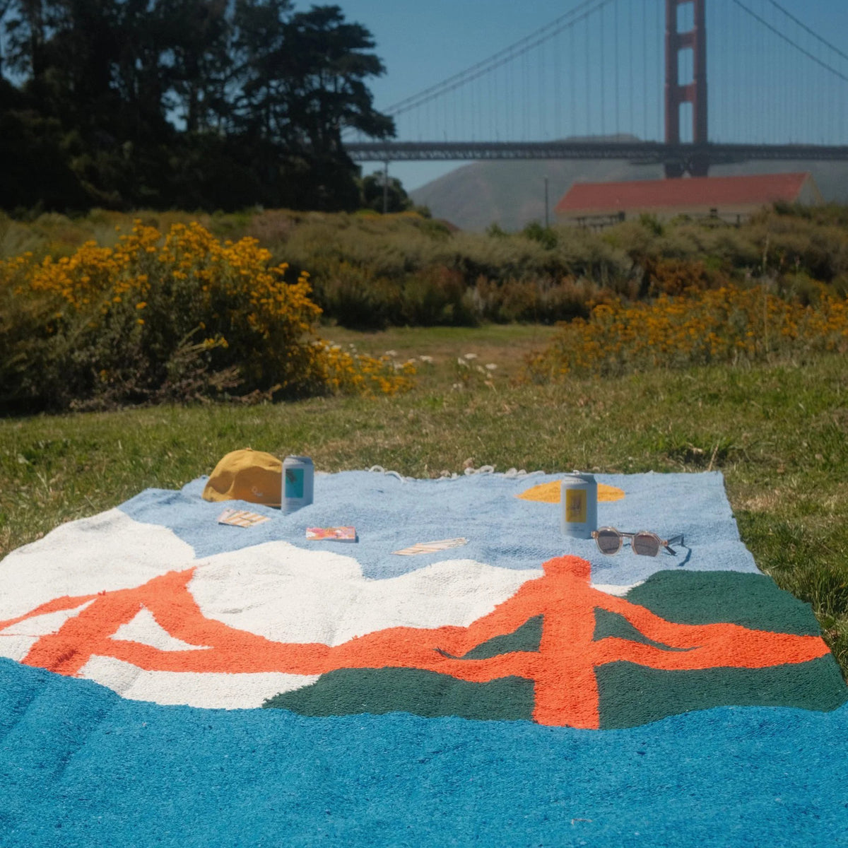 Blanket on grassy field with Golden Gate Bridge in background
