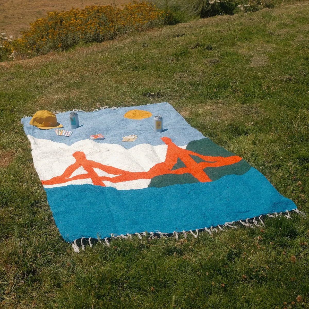 Colorful picnic blanket with Golden Gate Bridge design on a grassy field