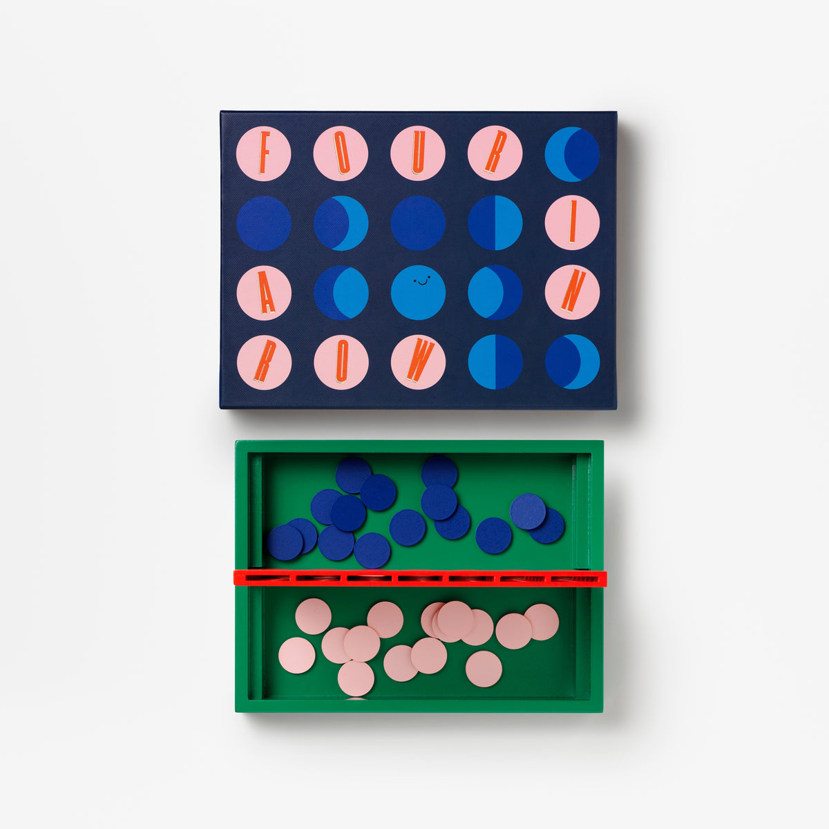 A children's geometric game set shown against a plain white background, featuring a dark blue board with pink and blue circular pieces, a green tray with blue and pink discs, and a red divider.