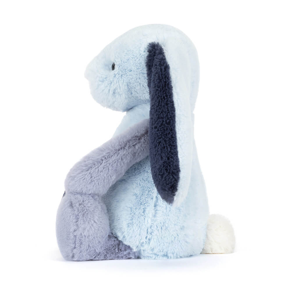 Plush toy rabbit with light blue and dark blue ears on a white background