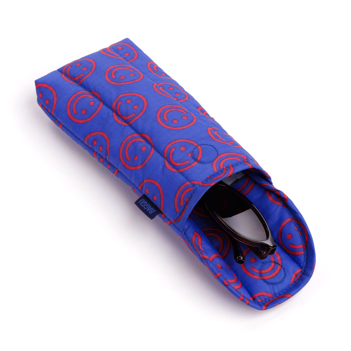 A blue quilted sunglasses case with a red smiley face pattern, shown on a white background with a pair of sunglasses inside.