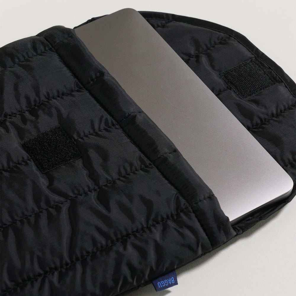 Laptop inside sleeve.