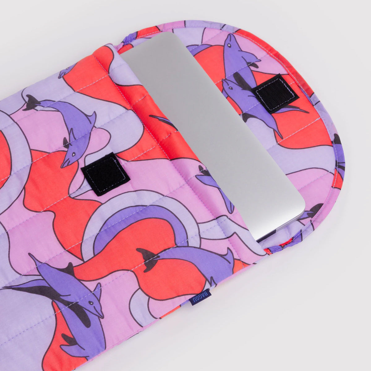 Colorful laptop sleeve with dolphin pattern on a white background