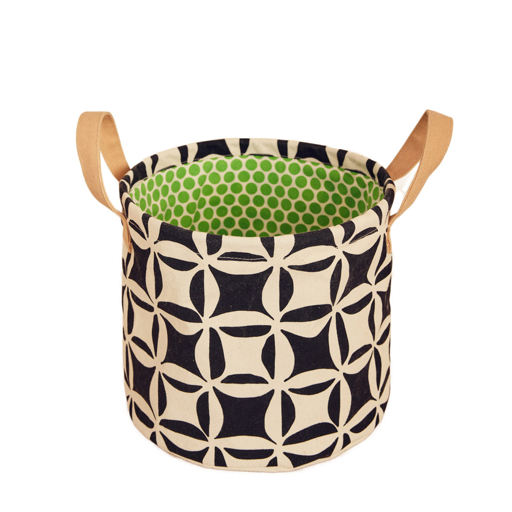 Fabric storage basket with geometric pattern and green interior on a white background